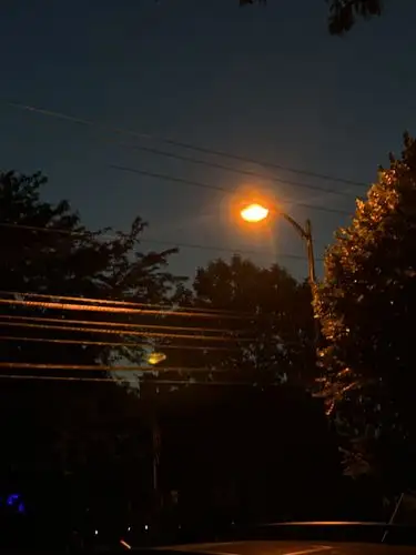 Night's embrace, lit by a single golden glow.